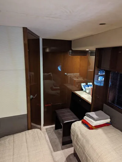  Yacht Photos Pics Interior of 2010 Princess 72 Motor Yacht with twin beds and wooden cabinetry.