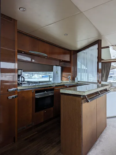  Yacht Photos Pics Luxurious kitchen interior of 2010 Princess 72 Motor Yacht with modern appliances and wood finish.