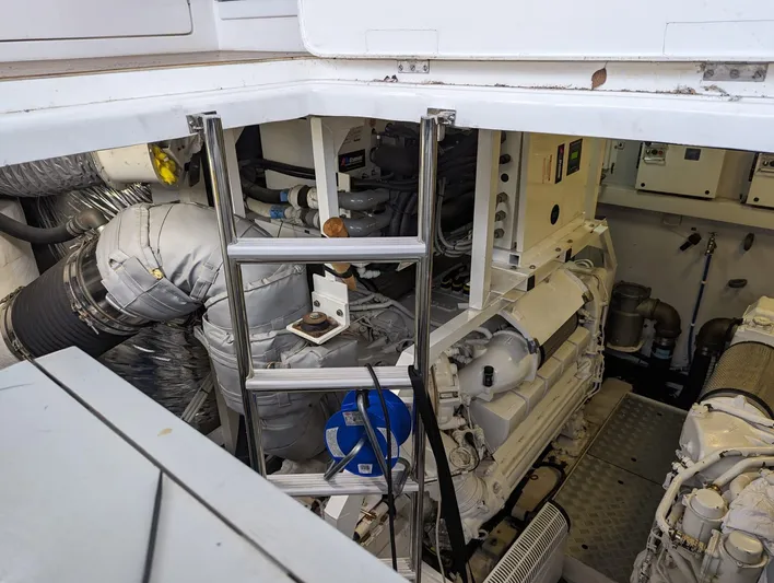  Yacht Photos Pics Engine room of a 2010 Princess 72 Motor Yacht with visible machinery and ladder.
