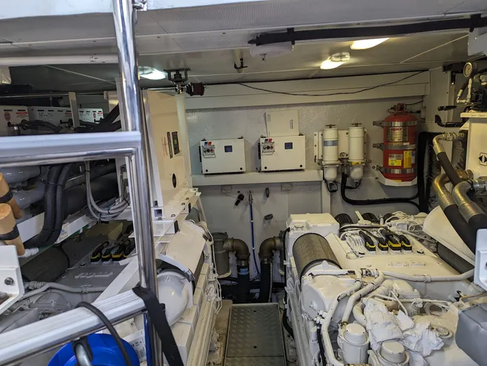  Yacht Photos Pics Engine room of a 2010 Princess 72 Motor Yacht, featuring machinery and safety equipment.
