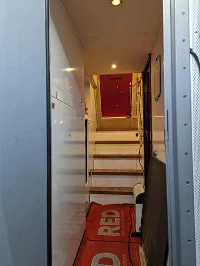  Yacht Photos Pics Stairway inside 2010 Princess 72 Motor Yacht with red carpet and modern lighting.