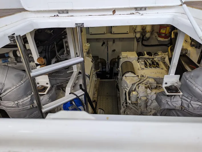  Yacht Photos Pics Engine room of a 2010 Princess 72 Motor Yacht, featuring dual engines and maintenance ladder.
