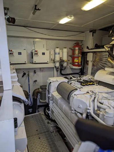  Yacht Photos Pics Engine room of a 2010 Princess 72 Motor Yacht, featuring machinery and control panels.