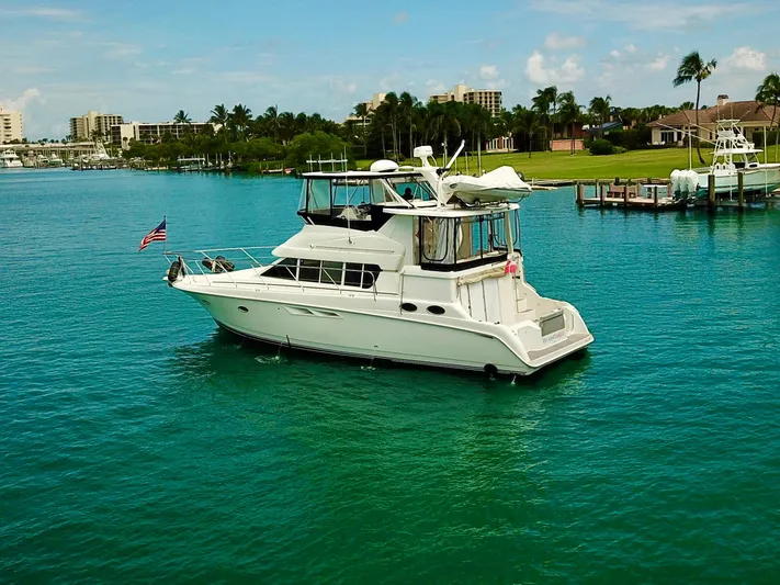  Yacht Photos Pics 2000 Silverton 442 Cockpit Motor Yacht on turquoise water near a marina.