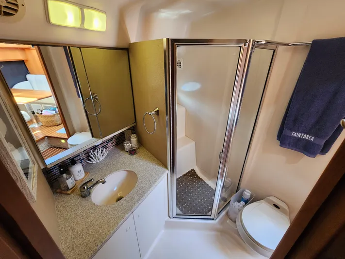  Yacht Photos Pics Luxurious bathroom in 2000 Silverton 442 Cockpit Motor Yacht with shower and vanity.