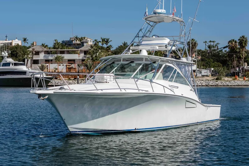  Yacht Photos Pics 2005 Cabo 40 Express yacht cruising in a scenic marina setting.