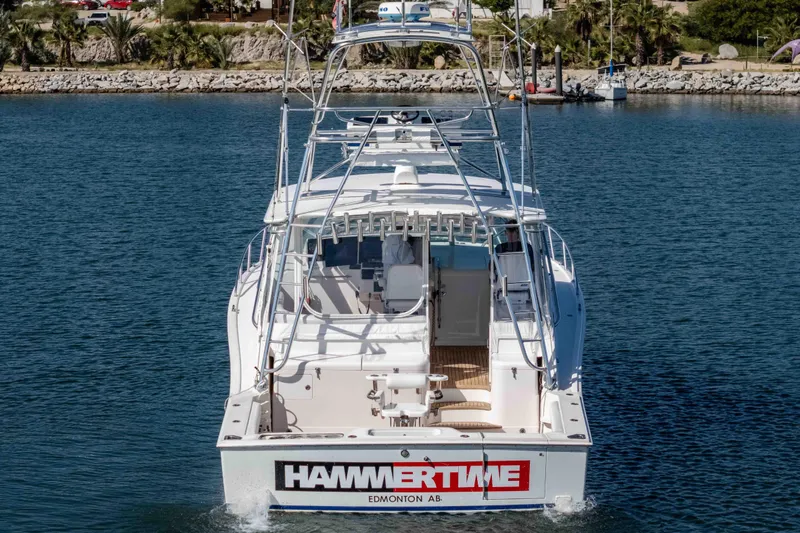  Yacht Photos Pics 2005 Cabo 40 Express yacht on water, rear view with "HAMMERTIME" text.
