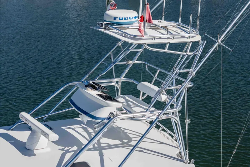  Yacht Photos Pics 2005 Cabo 40 Express boat tower with radar and seating, on calm water.