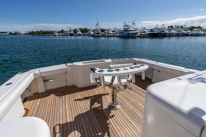  Yacht Photos Pics 2005 Cabo 40 Express yacht deck with fishing rod holders, overlooking marina.
