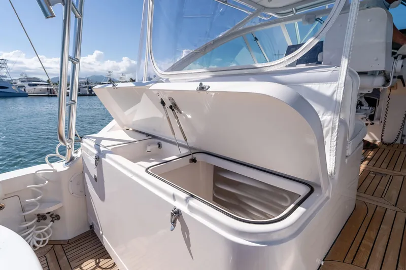  Yacht Photos Pics 2005 Cabo 40 Express boat with open storage compartment on deck, docked at marina.