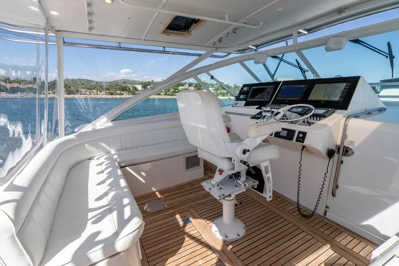  Yacht Photos Pics 2005 Cabo 40 Express yacht helm with white seating and advanced navigation systems.