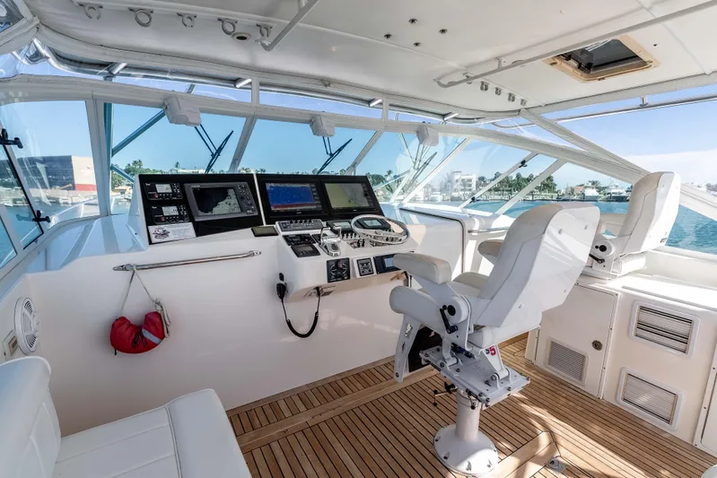  Yacht Photos Pics 2005 Cabo 40 Express yacht helm with modern navigation equipment and comfortable seating.