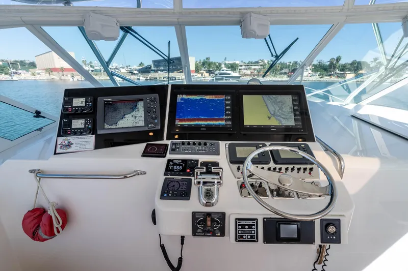  Yacht Photos Pics Helm of 2005 Cabo 40 Express yacht with navigation screens and controls.