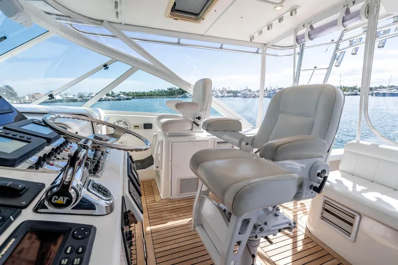  Yacht Photos Pics Interior of 2005 Cabo 40 Express yacht with helm station and luxurious seating.