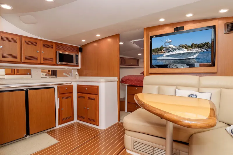  Yacht Photos Pics Luxurious interior of 2005 Cabo 40 Express yacht with modern amenities and cozy seating.