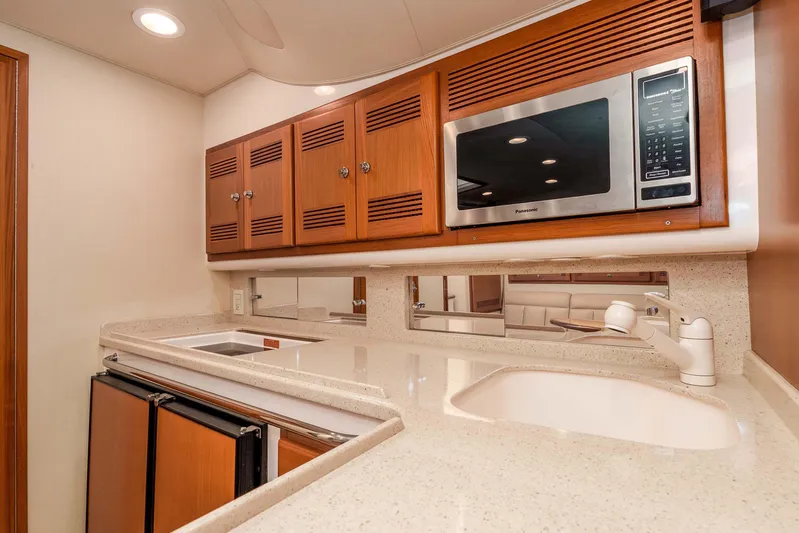  Yacht Photos Pics Luxurious 2005 Cabo 40 Express yacht kitchen with modern appliances and elegant wood cabinetry.