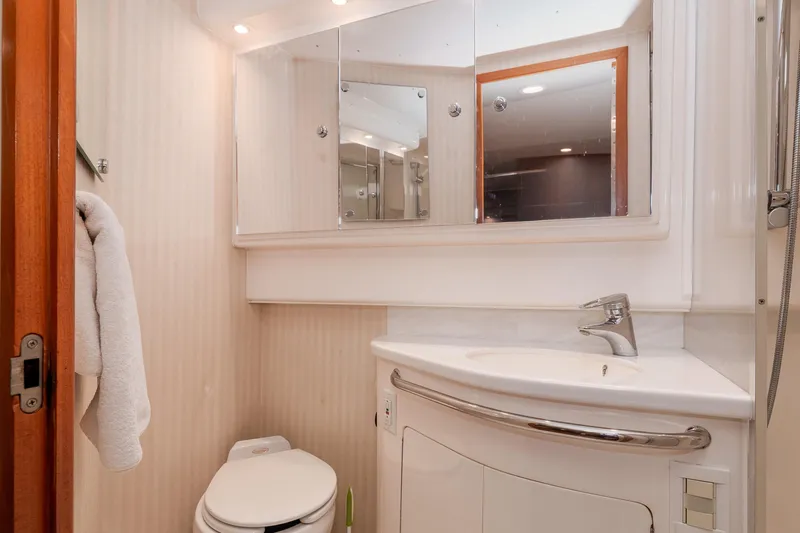  Yacht Photos Pics Luxurious bathroom in 2005 Cabo 40 Express yacht with modern fixtures and elegant design.