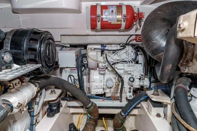  Yacht Photos Pics Engine room of 2005 Cabo 40 Express boat with visible machinery and fire extinguisher.