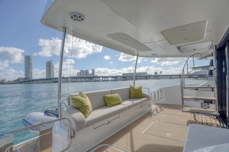 Hawkeye Yacht Photos Pics Luxurious 2022 Fountaine Pajot MY6 yacht deck with comfortable seating and scenic waterfront view.