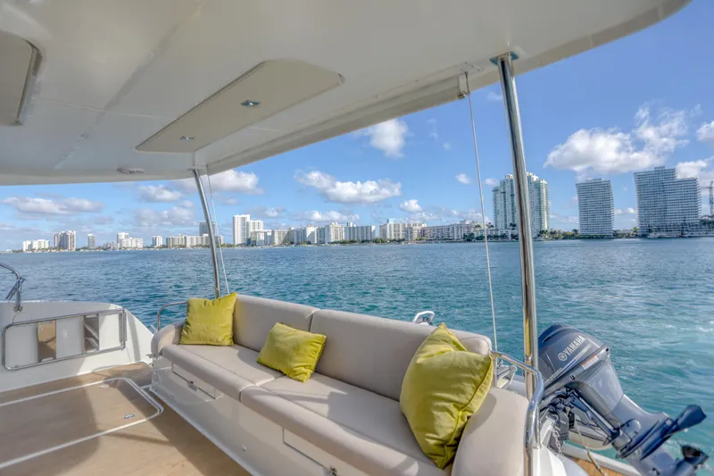 Hawkeye Yacht Photos Pics 2022 Fountaine Pajot MY6 yacht with city skyline view, featuring a spacious deck and comfortable seating.