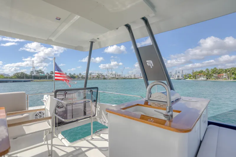 Hawkeye Yacht Photos Pics 2022 Fountaine Pajot MY6 yacht deck with sink, overlooking scenic waterfront.