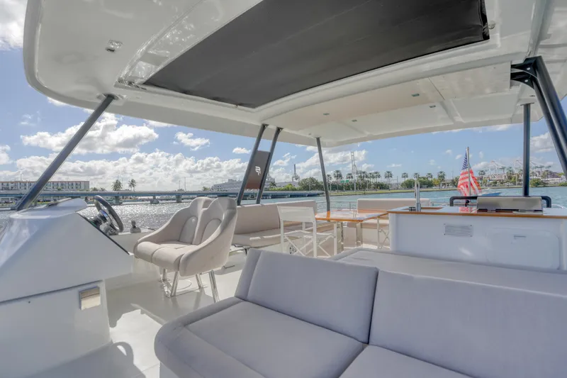 Hawkeye Yacht Photos Pics Luxurious 2022 Fountaine Pajot MY6 yacht interior with spacious seating and scenic water views.