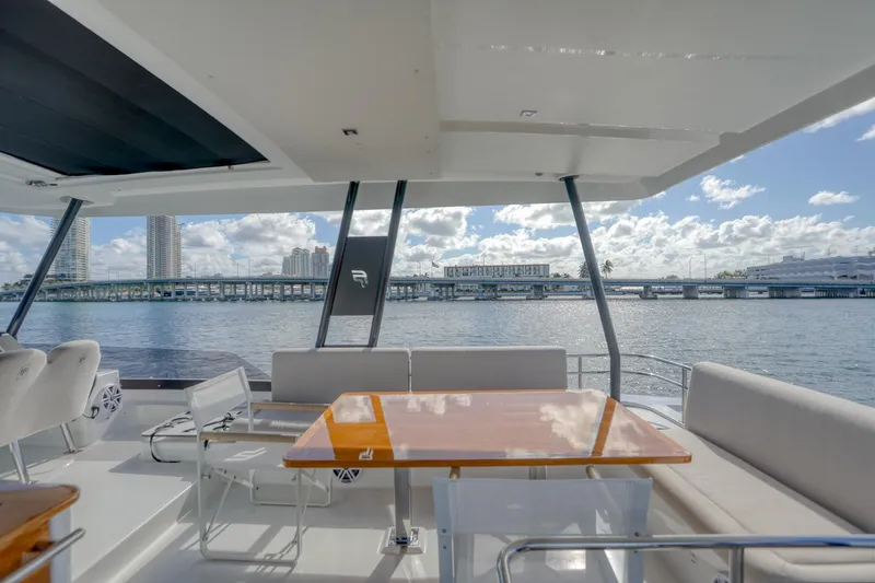 Hawkeye Yacht Photos Pics Luxury Fountaine Pajot MY6 2022 yacht deck with seating, overlooking scenic waterfront views.