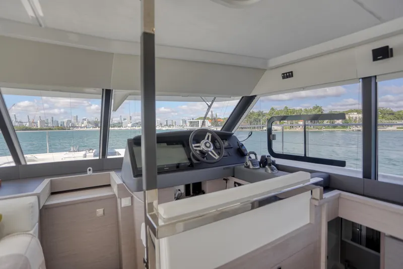 Hawkeye Yacht Photos Pics 2022 Fountaine Pajot MY6 yacht interior with helm, overlooking scenic waterfront.