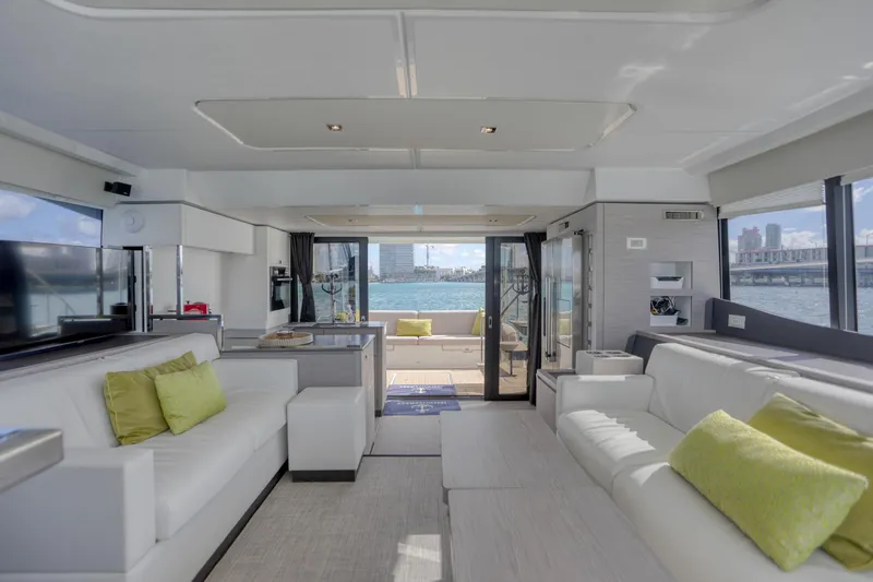Hawkeye Yacht Photos Pics Luxurious interior of 2022 Fountaine Pajot MY6 yacht with modern furnishings and waterfront view.