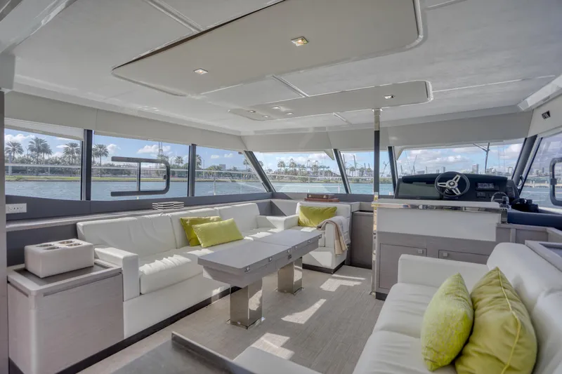 Hawkeye Yacht Photos Pics Luxurious interior of 2022 Fountaine Pajot MY6 yacht with modern seating and panoramic windows.