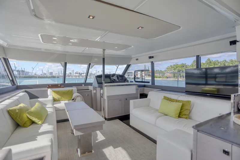 Hawkeye Yacht Photos Pics Luxurious interior of 2022 Fountaine Pajot MY6 yacht with modern seating and panoramic windows.