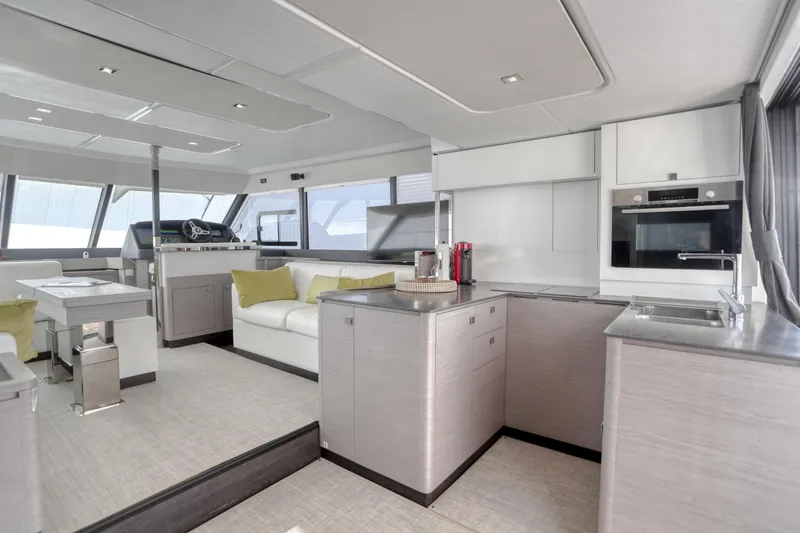 Hawkeye Yacht Photos Pics Luxurious interior of 2022 Fountaine Pajot MY6 yacht with modern kitchen and seating area.