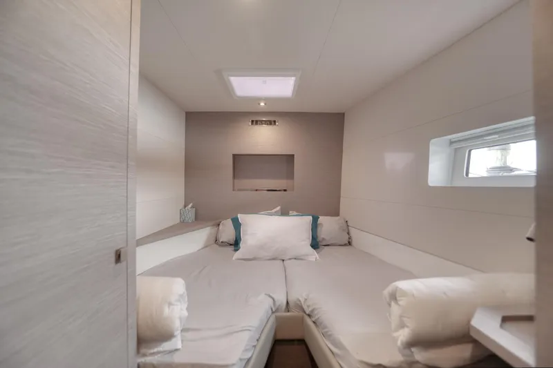 Hawkeye Yacht Photos Pics Luxurious cabin interior of 2022 Fountaine Pajot MY6 yacht, featuring cozy bedding and modern design.