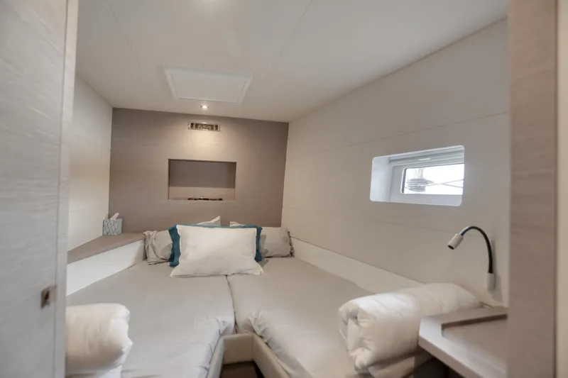 Hawkeye Yacht Photos Pics Luxurious cabin interior of 2022 Fountaine Pajot MY6 yacht, featuring modern design and cozy bedding.