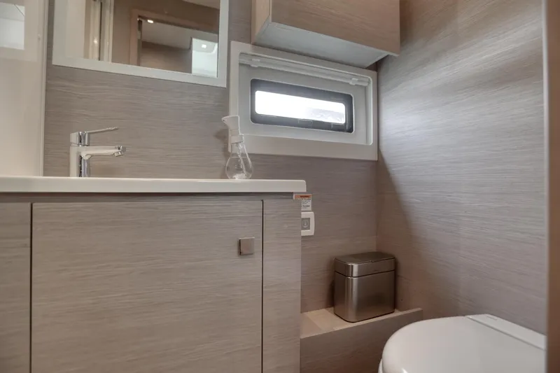 Hawkeye Yacht Photos Pics Modern bathroom interior on 2022 Fountaine Pajot MY6 yacht, featuring sleek design and compact amenities.