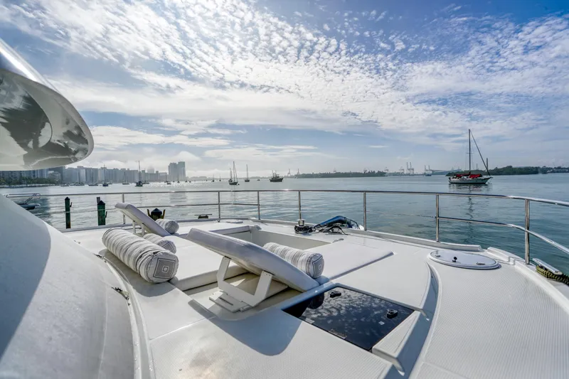 Hawkeye Yacht Photos Pics Fountaine Pajot MY6 2022 yacht deck with scenic waterfront view and clear blue sky.
