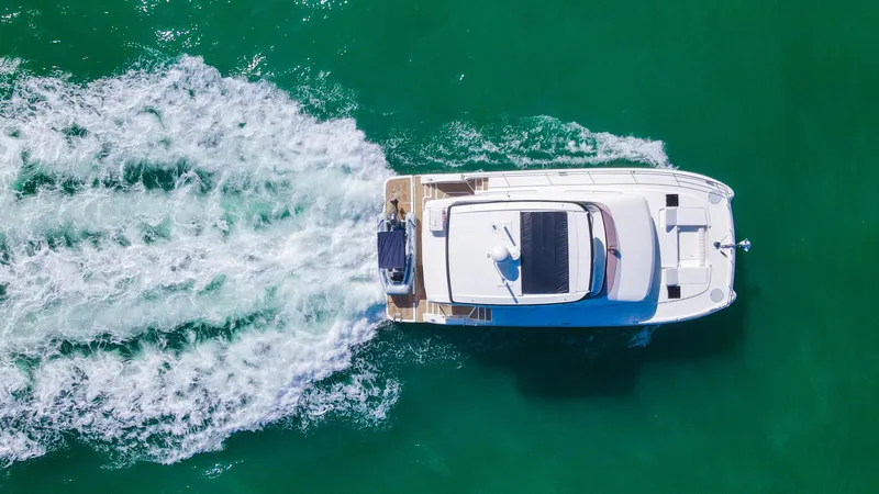 Hawkeye Yacht Photos Pics Aerial view of 2022 Fountaine Pajot MY6 yacht cruising on turquoise water.