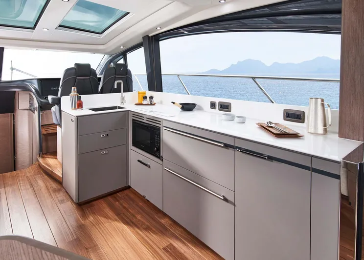  Yacht Photos Pics Luxurious interior of 2025 Princess V55 Express yacht with modern kitchen and ocean view.
