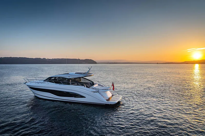  Yacht Photos Pics 2025 Princess V55 Express yacht cruising at sunset on open water.