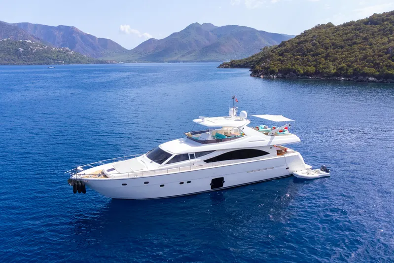 Astarte Yacht Photos Pics Luxurious 2007 Ferretti Yachts 830 cruising in scenic blue waters with mountainous backdrop.