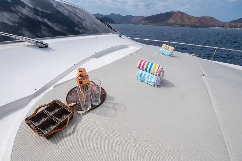 Astarte Yacht Photos Pics Luxurious 2007 Ferretti Yachts 830 deck with towels and drinks, scenic ocean view.