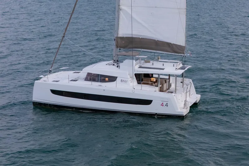 Point Clear Yacht Photos Pics 2023 Bali 4.4 catamaran sailing on open water, showcasing sleek design and spacious deck.