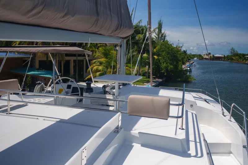 Point Clear Yacht Photos Pics 2023 Bali 4.4 yacht on a serene canal with lush greenery.