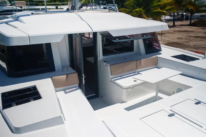 Point Clear Yacht Photos Pics 2023 Bali 4.4 yacht deck with seating and table, featuring modern design elements.