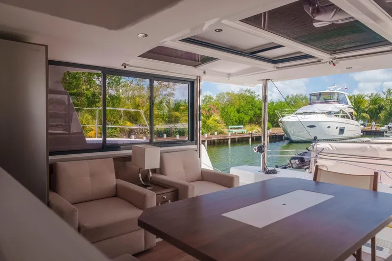 Point Clear Yacht Photos Pics Luxurious interior of 2023 Bali 4.4 yacht with marina view and modern furnishings.