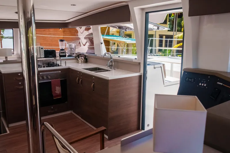 Point Clear Yacht Photos Pics Modern kitchen interior on 2023 Bali 4.4 yacht, featuring sleek appliances and wooden cabinetry.