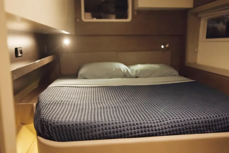 Point Clear Yacht Photos Pics 2023 Bali 4.4 yacht cabin with cozy bed and ambient lighting.