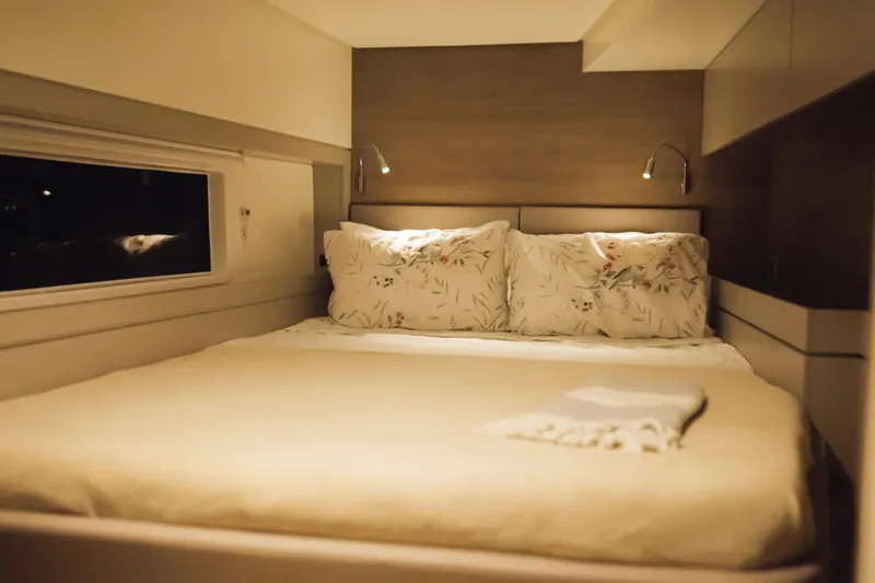 Point Clear Yacht Photos Pics Cozy bedroom in 2023 Bali 4.4 model with soft lighting and floral pillows.