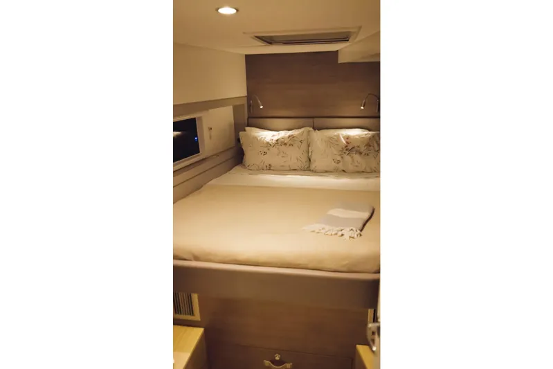 Point Clear Yacht Photos Pics Cozy bedroom in 2023 Bali 4.4 model yacht with elegant bedding and ambient lighting.