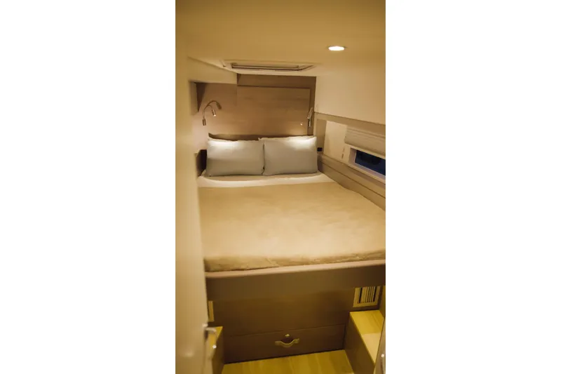 Point Clear Yacht Photos Pics Cozy bedroom interior in 2023 Bali 4.4 model with modern lighting and wooden accents.